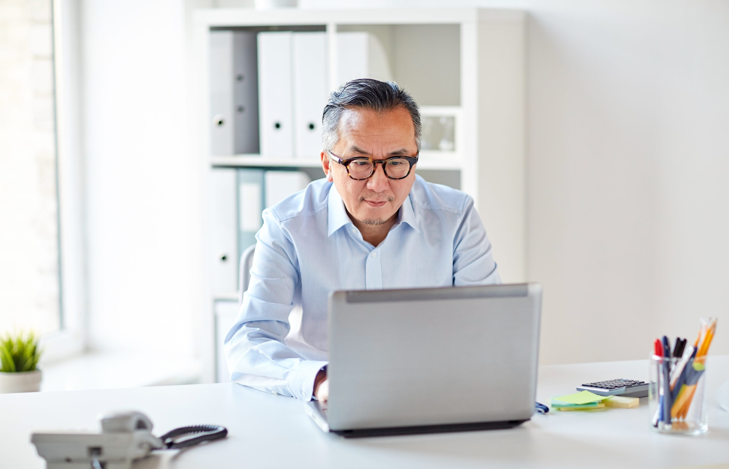 Man on laptop accessing Online Therapy